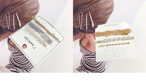 Detail view of pearl and marble pattern alloy hair clip sets displayed on white cards