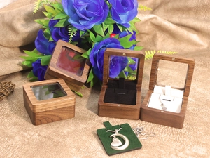 Detail of walnut jewelry box with glass window and soft velvet lining for rings