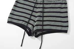 Detail of striped knit shorts with adjustable drawstring waist and fine texture