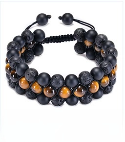Detail of triple-layer beaded bracelet featuring matte onyx, lava stone, and blue tiger eye