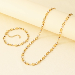 Detail of gold stainless steel necklace and bracelet set with round cubic zirconia crystals