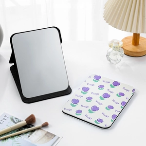 Detail of a portable PU leather folding mirror with purple tulip pattern on a vanity desk