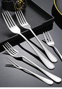 Polished stainless steel fork set with varied sizes on dark textured background