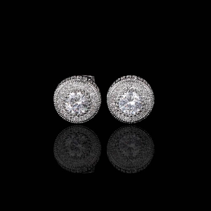 Macro shot of silver round halo stud earrings with large central cubic zirconia stones