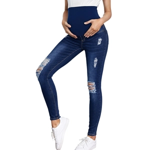 Close-up of maternity jeans featuring high-waist support and trendy distressed ripped holes