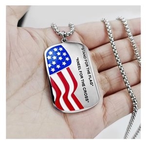 Detail of USA flag heart pendant on palm with Stand for the Flag engraving