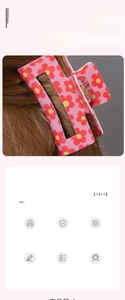 Macro detail of a large pink floral square hair claw clip with yellow and red flower patterns