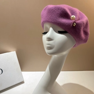 Detail of purple wool beret with white pearl and golden metal bead embellishments