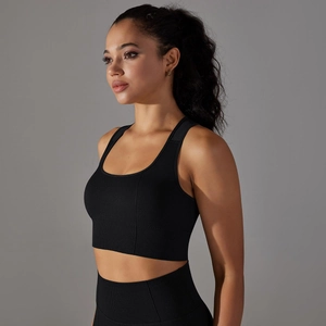 Detail view of black seamless sports bra showing breathable knit texture and racerback fit