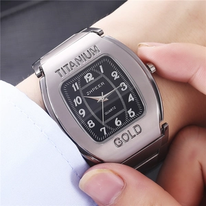 Close-up of tonneau-shaped quartz watch with black dial and silver stainless steel strap