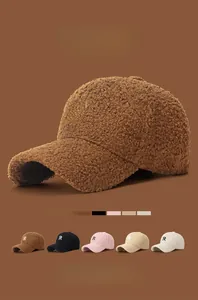 Close-up of sherpa baseball cap showing the fluffy texture and embroidered R letter logo