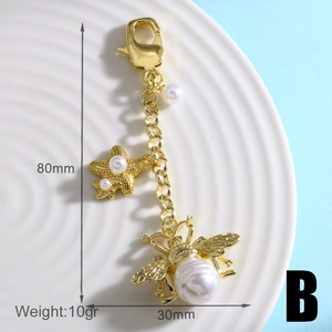 Detailed view of gold bee keychain with size specs 80mm length and 30mm width