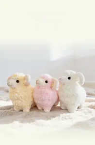 Detailed close-up of three cute plush sheep dolls in white, pink, and yellow colors