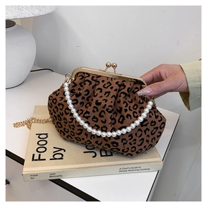 Close-up of leopard print handbag with pearl decorative chain and gold metal clasp