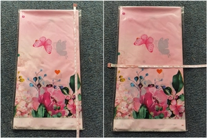Close-up of strawberry picnic party tablecloth showing 30cm size measurement with tape