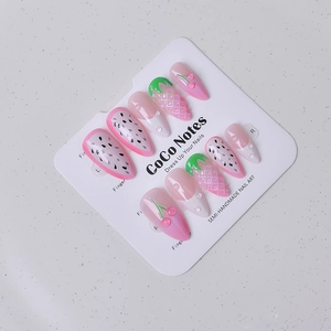 Macro detail of 3D embossed strawberry and cherry fruit nail art on long almond nails