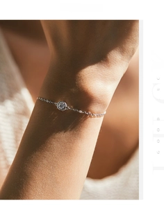 Close-up of a S925 silver bracelet featuring a round solitaire diamond on a female wrist