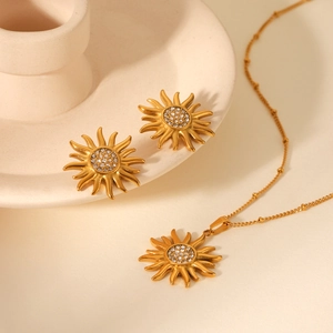 Detail view of 18K gold plated sunflower necklace and earrings set with zircons