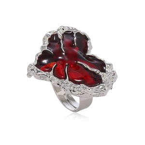 Irregular red resin ring with silver metal frame in a minimalist avant-garde design