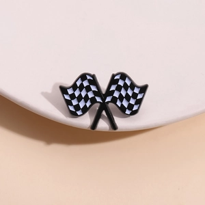 Racing themed checkered flag brooch with black and white enamel finish on display stand