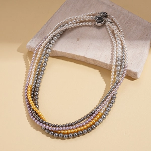 Elegant multi-strand pearl necklace featuring white, grey, purple and gold beads