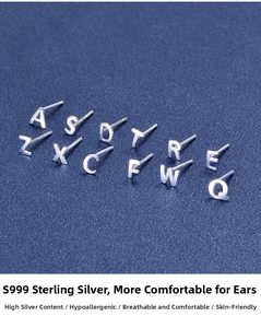 Macro detail of S999 sterling silver letter stud earrings with hypoallergenic finish