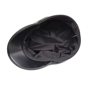 Detail view of black PU leather baker boy hat showing inner fabric lining and silver button