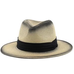 Detail of hand-woven straw fedora hat with unique black gradient spray paint finish