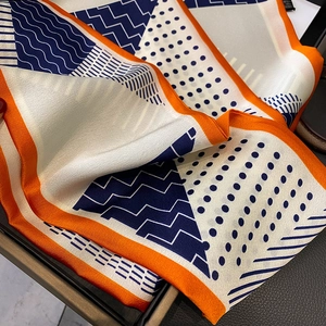 Navy blue polka dot and stripe geometric silk scarf with orange contrast hem
