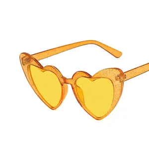 Sparkly heart shaped sunglasses with orange glitter frame and yellow lenses for summer