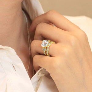Detailed close-up of emerald-cut square diamond engagement ring set on a finger