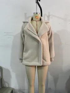 Detail of beige suede jacket showing warm faux shearling lining and wide lapel design