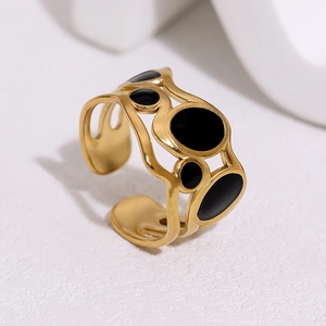 Close-up of 18k gold plated irregular open ring with black enamel oval details