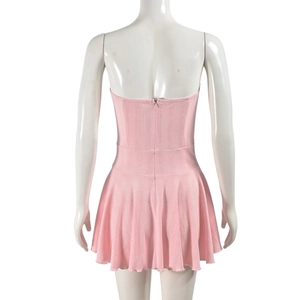 Detail of light pink knitted dress back with vertical texture and pleated skirt waist
