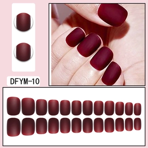 Macro shot of matte wine red press-on nails with square round shape and 24-piece full set