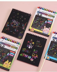 Creative rainbow scratch art notebook set with wooden stylus tool on a soft pink background
