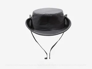 Detail of dark grey sun hat with breathable metal vents and adjustable drawstring