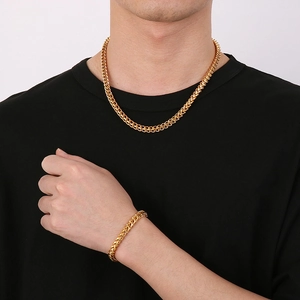 Men's gold-plated curb chain necklace and bracelet set shown on a male model
