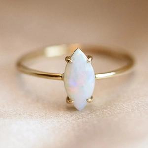 Macro view of marquise-cut opal stone on a sleek gold-finished S925 silver ring
