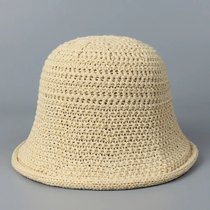 Detailed close-up showing the hollow-out knit texture of the beige bucket hat
