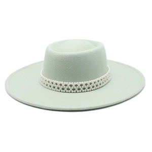 Detail of mint green wool fedora hat featuring three rows of woven pearl trim