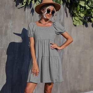 Detailed view of grey short sleeve knit dress with square neck and layered ruffle hem
