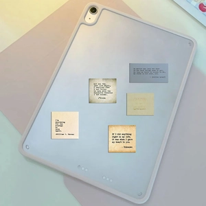 Close-up of vintage inspirational quote stickers on a laptop case with typewriter font