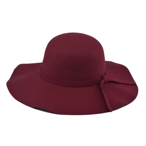 Detail of burgundy wool felt wide brim hat featuring a decorative ribbon bow