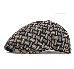 Detail of vintage British style flat cap with woven black and grey plaid texture
