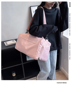 Pink waterproof gym bag with adjustable strap shown in a modern home lifestyle setting