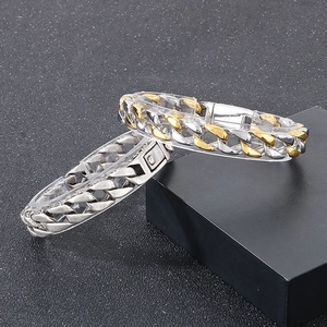 Mens vintage 11mm Cuban chain bracelets in silver and dual-tone finish on luxury display
