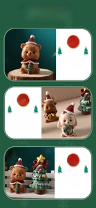 Detail of Christmas animal figurines featuring a reindeer, bear, and tree in a micro landscape