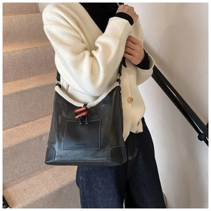 Close-up of winter bucket bag with faux fur trim and vintage wooden horn button detail