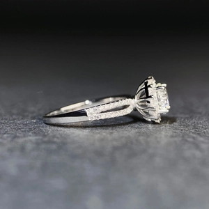 Macro shot of 925 silver ring featuring a round cut moissanite and pave diamond accents